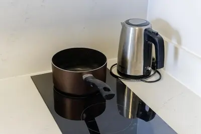 a coffee maker and a cup on a counter at One9Five Asoke Rama 9 \u6708\u79df 500mbps wifi in Bangkok
