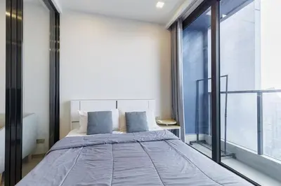 a bedroom with a bed and a large window at One9Five Asoke Rama 9 \u6708\u79df 500mbps wifi in Bangkok