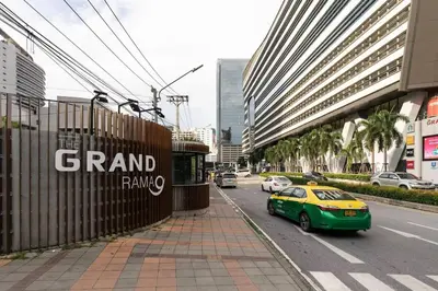 a green car parked on the side of a street at One9Five Asoke Rama 9 \u6708\u79df 500mbps wifi in Bangkok