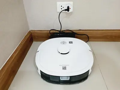 a white appliance plugged into an electrical outlet at Comfy Townhome 5min walk to 7-11 in Ban Nong Bua