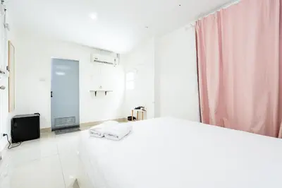 a white bathroom with a sink and a mirror at XX Oh My Nap BTS Nana - โอ้ มาย แน็ป บีทีเอส นานา in Bangkok