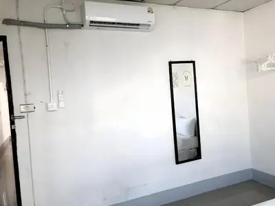 a mirror on a wall next to a white wall at XX Oh My Nap BTS Nana - โอ้ มาย แน็ป บีทีเอส นานา in Bangkok