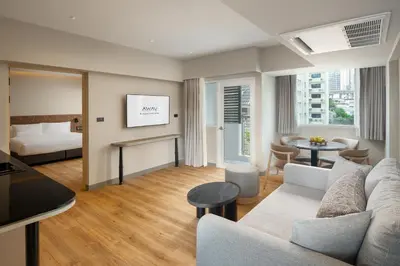 a living room with a couch and a bed at Away Bangkok Sukhumvit in Bangkok