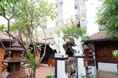 a group of white pigeons in front of a building at Yotaka Boutique Hotel Bangkok in Bangkok