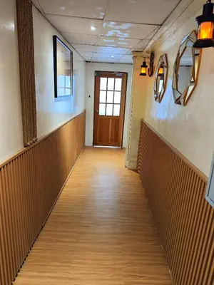 an empty hallway with a door in a building at latitude 13 Room & breakfast in Bangkok