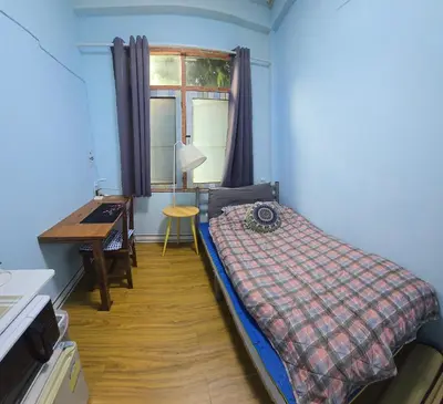 a bedroom with a bed and a desk and a window at 214 Lovely apartment with private bathroom and WiFi in Bangkok