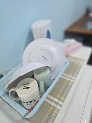 a drawer filled with dishes and cups and a pen at 214 Lovely apartment with private bathroom and WiFi in Bangkok