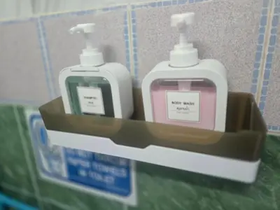 two bottles of soap are sitting on a shelf at 214 Lovely apartment with private bathroom and WiFi in Bangkok