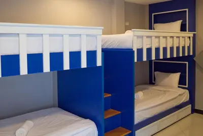 two bunk beds in a room with blue and white at The Secret Service in Bangkok
