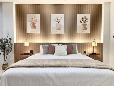 a bedroom with a large bed with flowers in vases at Studio Botanica I 2 mins to SRT in Bangkok