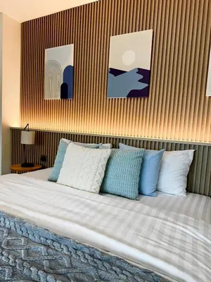 a bedroom with a bed with blue and white pillows at Indigo Studio 2 mins from SRT Wat Samien Nari in Bangkok