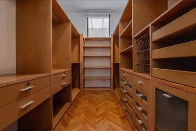 a walk in closet with wooden shelves and a window at Sukumvit Pool Villa 5BR 5-7min-walk to Thonglor Sky train in Khlong Toei