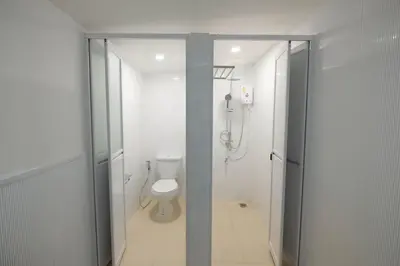 a white bathroom with a toilet and a shower at HOME175 Peaceful 2BR near BTS & IconSiam in Bangkok