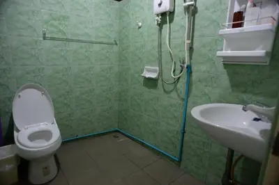 a bathroom with a toilet and a sink at Stay Hostel in Bangkok