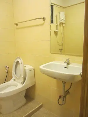 a bathroom with a toilet and a sink at Stay Hostel in Bangkok
