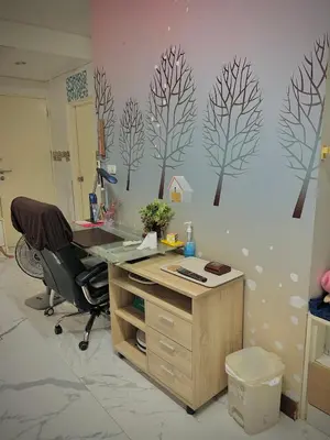 an office with a desk with a chair and trees on the wall at Condo In Bangkok With Pool and Garden in Sathani Ban Hua Mak