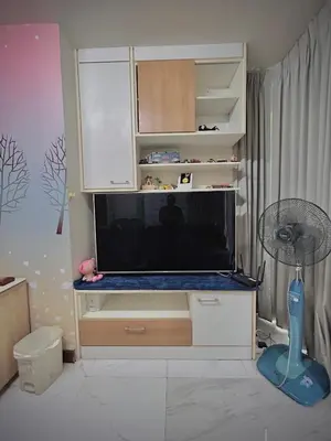 a entertainment center with a large screen tv in a room at Condo In Bangkok With Pool and Garden in Sathani Ban Hua Mak