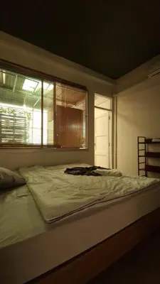 a bed in a bedroom with a window at Casita Hostel House Bangkok in Bangkok