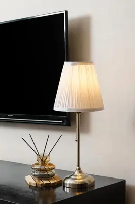 a lamp on a table next to a tv at Azure Dreams King Suite Retreat near BTS & Fast WiFi in Khlong Toei