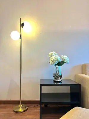 a vase of flowers on a table next to a lamp at Azure Dreams King Suite Retreat near BTS & Fast WiFi in Khlong Toei