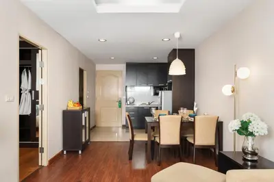 a kitchen and dining room with a table and chairs at Azure Dreams King Suite Retreat near BTS & Fast WiFi in Khlong Toei