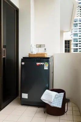 a small refrigerator with a basket on top of it at Jungle Dream King Bed Oasis with Balcony & High-Speed WiFi in Khlong Toei