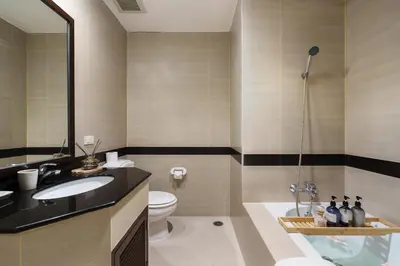 a bathroom with a sink and a toilet and a shower at Jungle Dream King Bed Oasis with Balcony & High-Speed WiFi in Khlong Toei