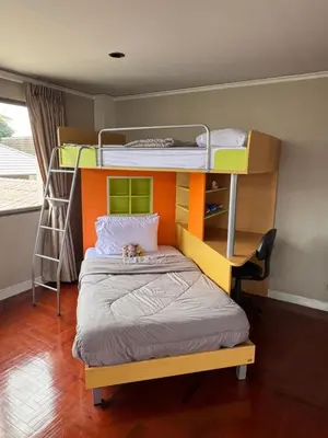 a bedroom with bunk beds with a bear laying on the bed at Urban Grace in Bangkok