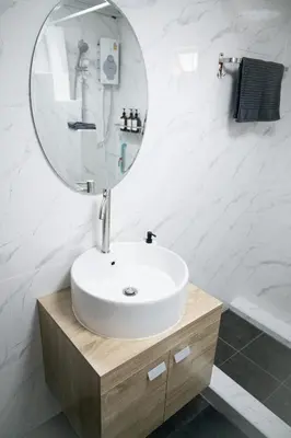 a bathroom with a sink and a mirror at Urban Grace in Bangkok