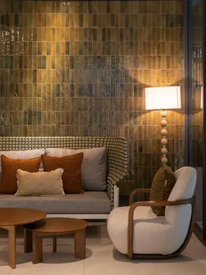 a living room with a couch and a chair at The Moment in Bangkok