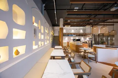 a row of tables and chairs in a restaurant at The Moment in Bangkok
