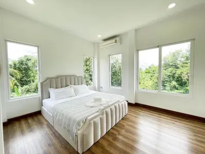 a white bedroom with a large bed with windows at Nordic Villa 5BR Pool, Jacuzzi, Rooftop and More in Ban Bang Krang