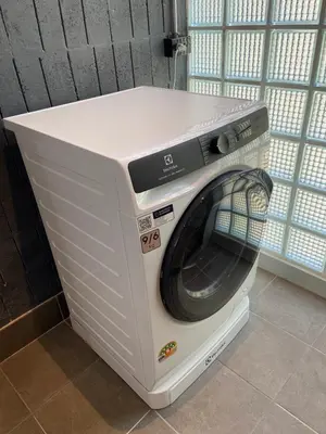 a washing machine sitting in a room at Bathtub, 2BR, 2BA, 120 Sqm, 6 Pax, Near BTS 7-11 in Bangkok