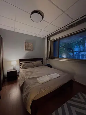 a bedroom with a large bed with a window at Mango Hostel - 420 Friendly in Bangkok