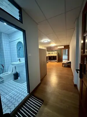a bathroom with a tub and a sink in a room at Mango Hostel - 420 Friendly in Bangkok
