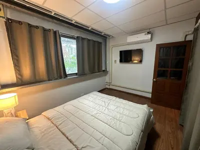 a small bedroom with a bed and a window at Mango Hostel - 420 Friendly in Bangkok