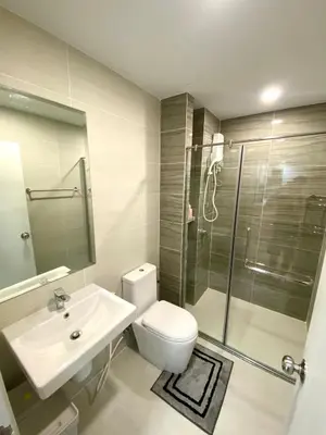 a bathroom with a toilet and a sink and a shower at 2BR Condo with Oldtown Bangkok Vibes, Steps from Wongwian Yai in Bangkok