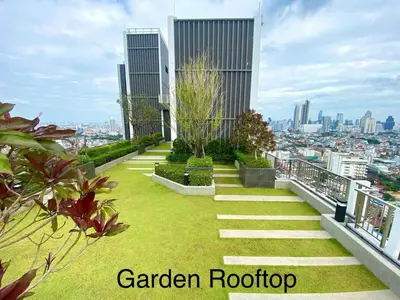 a garden on the roof of a building at 2BR Condo with Oldtown Bangkok Vibes, Steps from Wongwian Yai in Bangkok