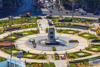 a fountain with a statue in the middle of a city at 2BR Condo with Oldtown Bangkok Vibes, Steps from Wongwian Yai in Bangkok