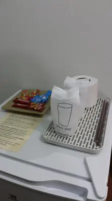 a paper bag sitting on top of a refrigerator at Nich Houses Craft&More in Sathani Sala Ya