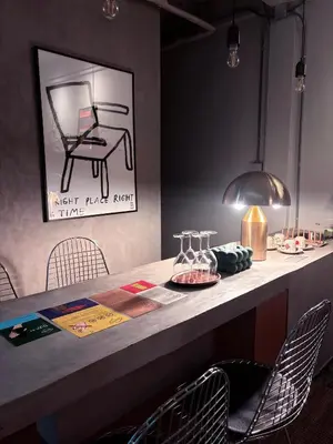 a bar with chairs and a table with a picture of a piano at Citrus House Phra-Arthit in Bangkok