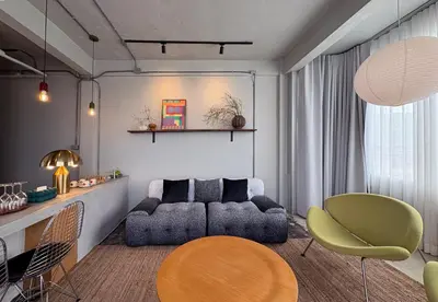 a living room with a couch and a table and chairs at Citrus House Phra-Arthit in Bangkok