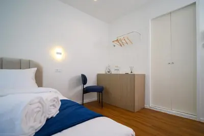 a bedroom with a bed and a dresser in it at Yummy House in Bangkok