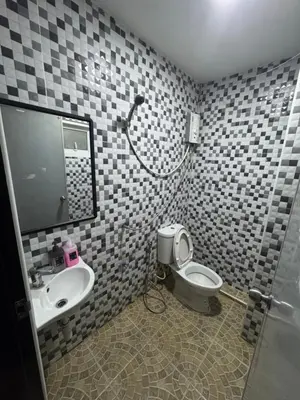 a bathroom with a toilet and a sink at WannaB Hostel in Khlong San