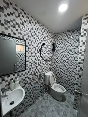 a bathroom with a sink and a toilet and a mirror at WannaB Hostel in Khlong San