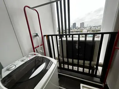 a bathroom with a sink and a balcony with a view at Comfy1BR at Bangson byBB in Bangkok
