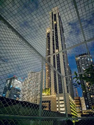 a view of a city skyline from behind a fence at Nan Square II in Bangkok
