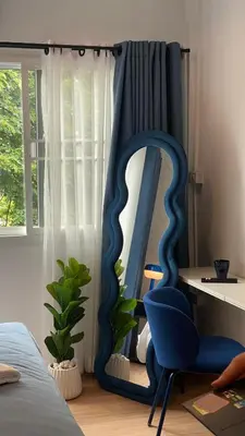 a blue chair and a mirror in a bedroom at Blue House 191 Hometel in Chinatown