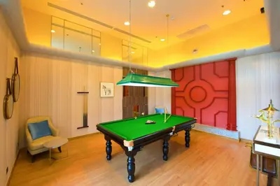 a pool table in a room with a red wall at Supalai Wellington 2 in Ban Na Song