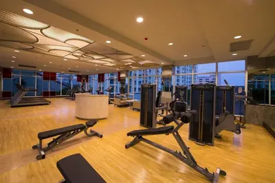 a gym with treadmills and exercise equipment in a building at Supalai Wellington 2 in Ban Na Song